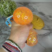 Load image into Gallery viewer, Squishy Toy - Viral Dumpling, Quick Squeeze Glitter - Orange
